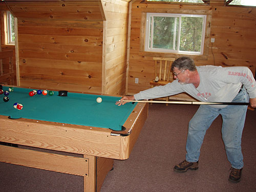 This is a photo of a man shooting pool