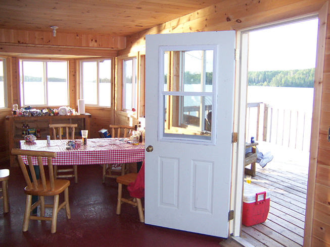 This is a photo taken from the kitchen looking out at the balcony and a nice view of the lake