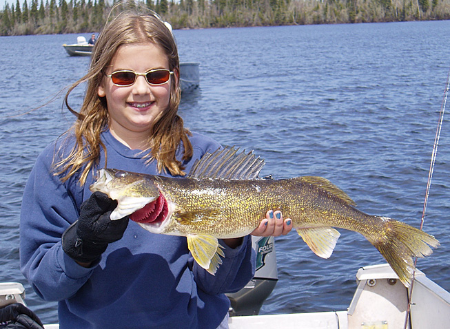 This is a photo of a young girl holding a 3 pound Walleye