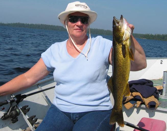 This is a photo of a woman holding a 4 pound Walleye