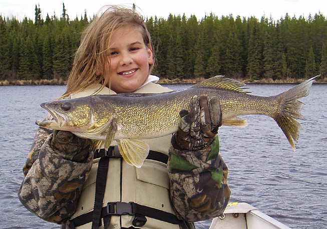 This is a photo of a young girl holding a 3 pound Walleye
