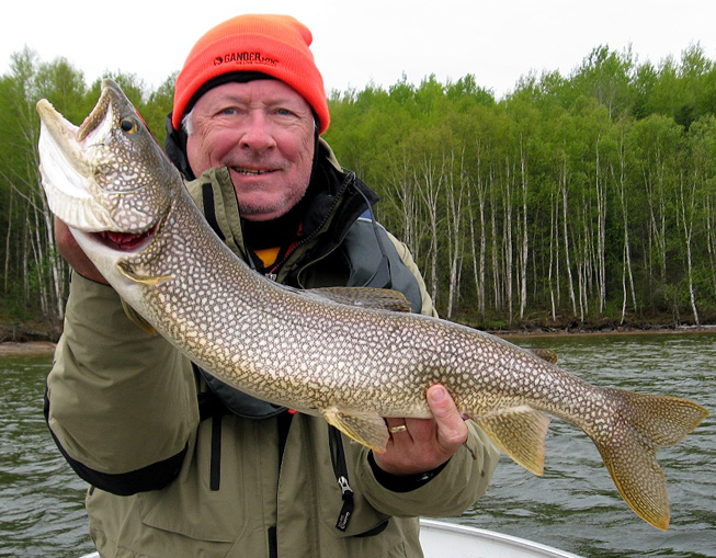 This is a photo of a man holding a 5 pound lake trout