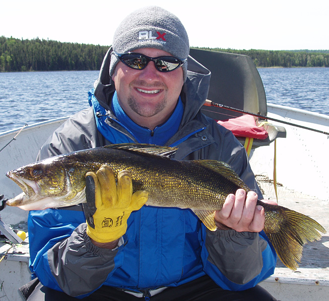 This is a photo of a man holding a nice Walleye